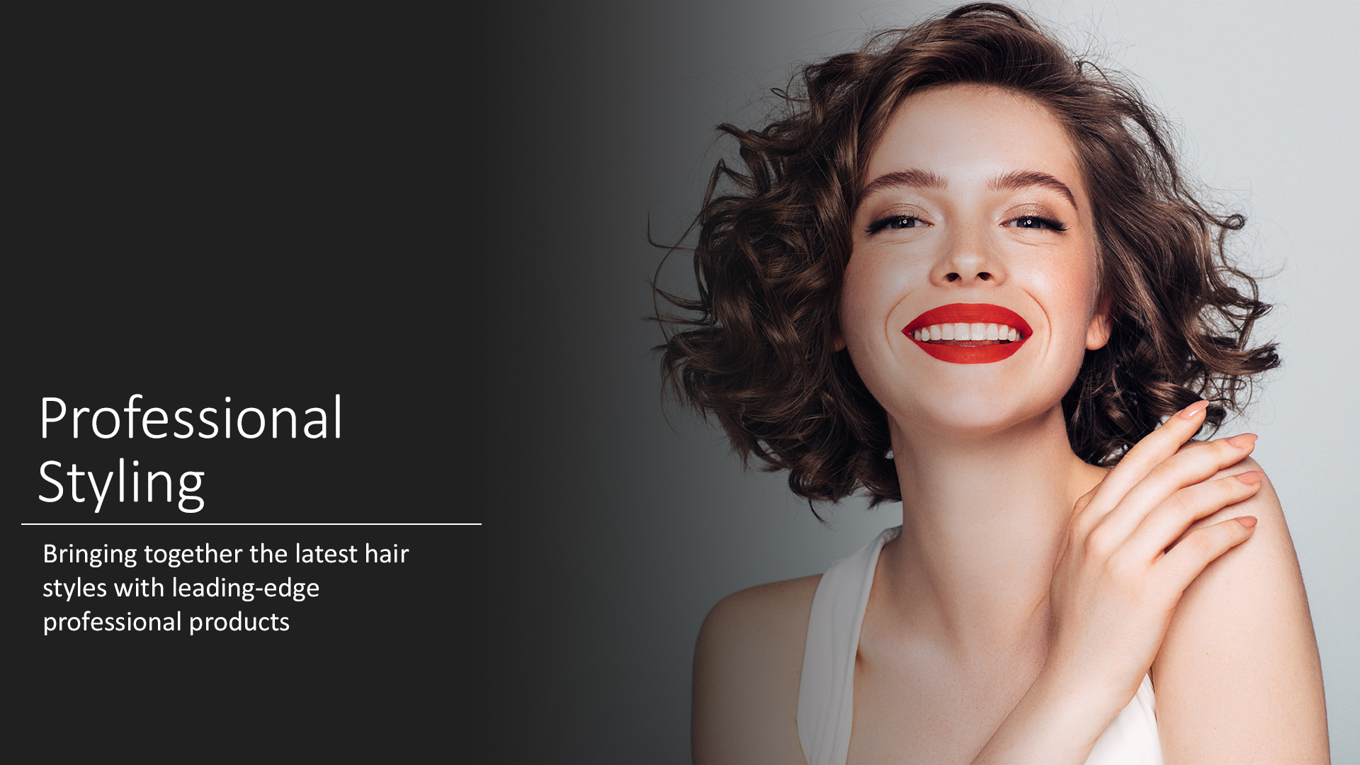 A woman with short hair and red lipstick smiles.