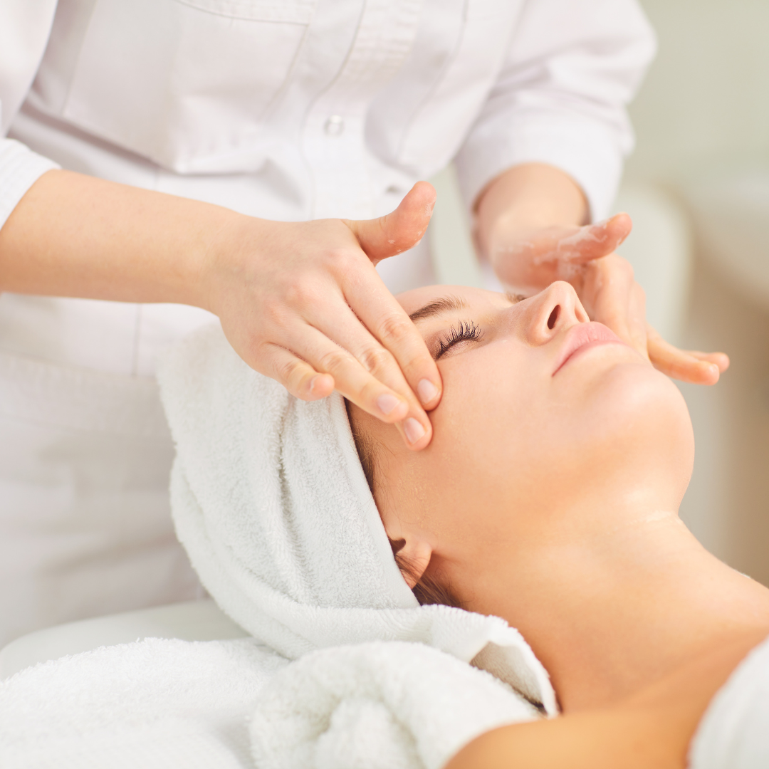 A woman getting her face washed by a professional